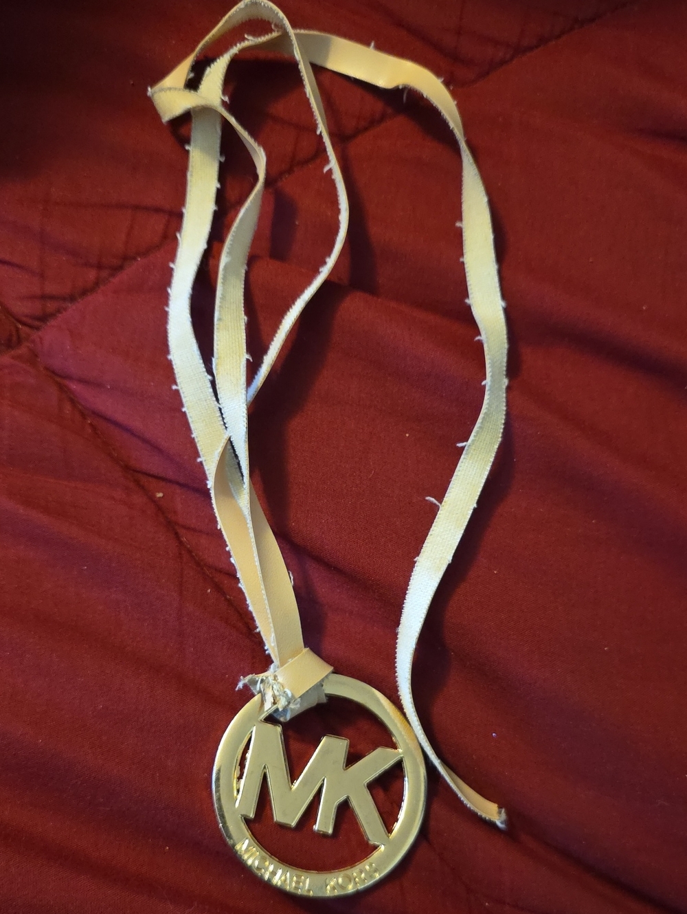 Michael Kors Cream Leather Strap with Gold MK Pendant